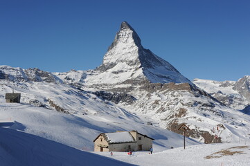 Matterhorn mountain peak  in Alps in winter with snow and clear blue sky in Cervinia, Italy and Zermatt, Switzerland. Beautiful and magnificent landscape on a sunny day