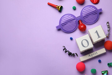 Date 1 APRIL with party decor for Fools' Day celebration on lilac background
