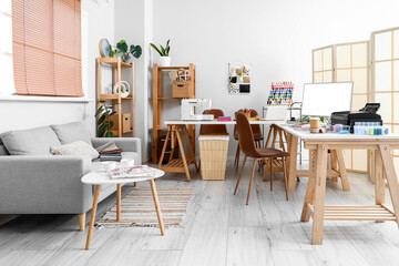 Interior of atelier with tailor's workplace and sofa