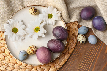 Fototapeta na wymiar Composition with beautiful Easter eggs and chamomile flowers on wooden background