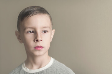 Photo of adorable young happy boy looking at camera.Isolated on the white background