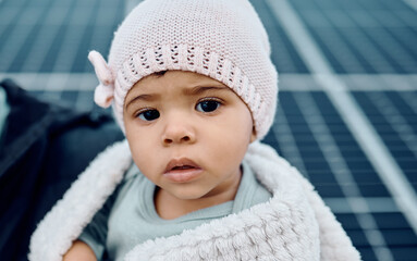 Portrait, baby and beanie with a girl child in a blanket during winter looking cute or adorable. Children, babies and face with a small female kid feeling curious or serious while keeping warm