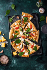 Italian pizza with feta cheese, tomato and basil