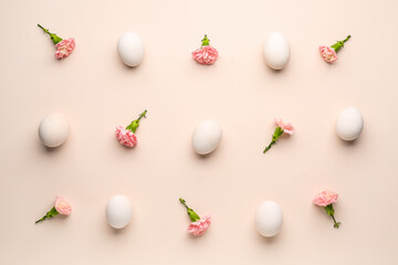 Composition with Easter eggs and carnation flowers on pink background