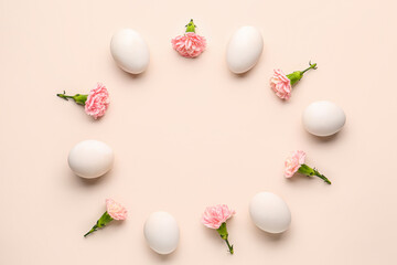 Fototapeta na wymiar Frame made of Easter eggs and carnation flowers on pink background