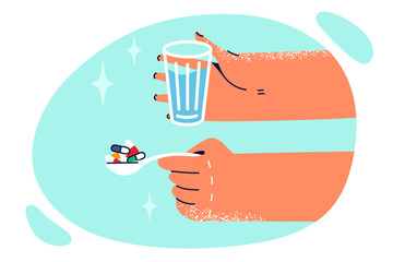 Hands with spoon filled with pills and glass of water for clinic patient during treatment of flu