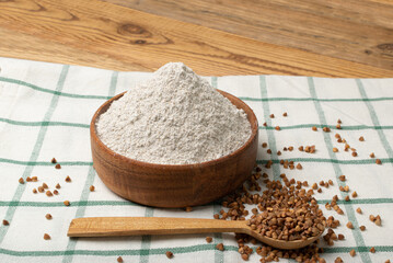 Buckwheat Flour Pile in Wood Bowl, Dry Buck Wheat Powder, Buckwheat Flour on Wooden Rustic Background
