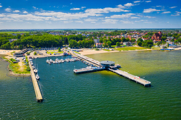 Pier and beach in Puck on the Bay of Puck at summer. Poland