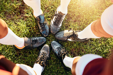 Shoes, huddle and team on grass field above for sports motivation, coordination or collaboration...