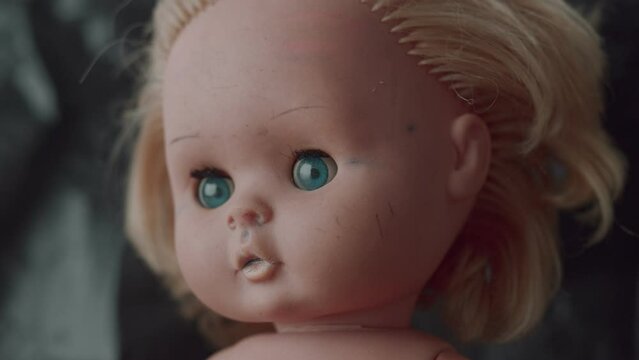 scary baby doll unnaturally raises its head, 4k footage