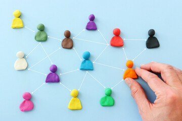 Colorful figures connected over blue background, concept of human resources and collaboration