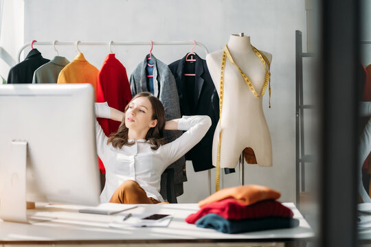 Relaxed woman sitting at table in studios.