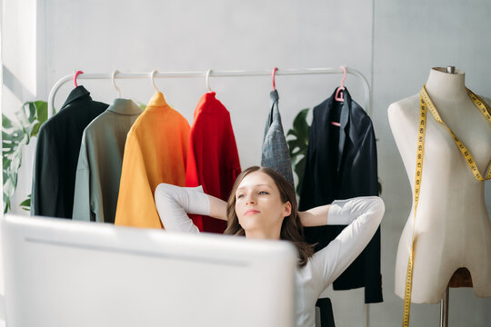 Relaxed woman sitting at table in studios.