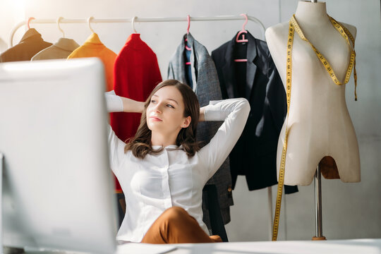Relaxed woman sitting at table in studios.