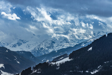 Cloud formation over snow covered mountains in winter, Kitzbühel, Tirol, Austria