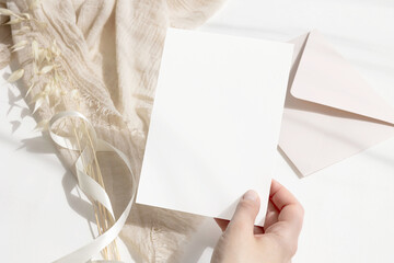 Invitation card mockup in girl's hand 