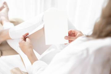 Invitation card mockup in girl's hand 
