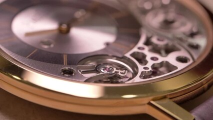 Close up on luxurious rotating mechanical Piaget wristwatch clockwork timepiece craftsmanship details