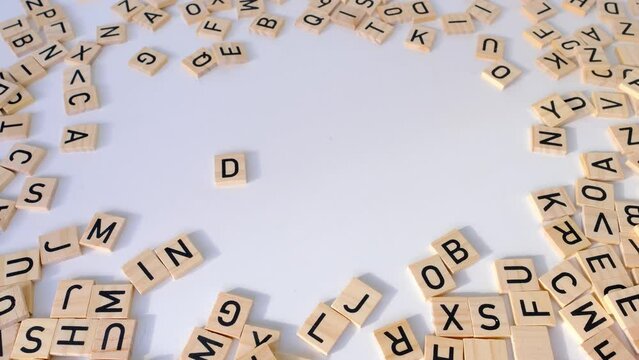 female hand close-up holds wooden alphabet blocks, DYSLEXIA word on white background, dyslexia awareness, help with reading, learning difficulties, human brain development, literacy problems concept