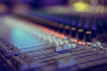 Master volume regulator on industrial sound mixer on stage. Professional audio mixing desk in...