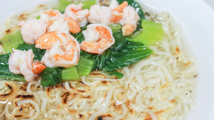 Noodle Soup with Shrimps and vegetable in white bowl isolated on white background. Traditional asian noodle soup.