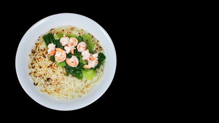 Noodle Soup with Shrimps and vegetable in white bowl isolated on black background. Traditional asian noodle soup.