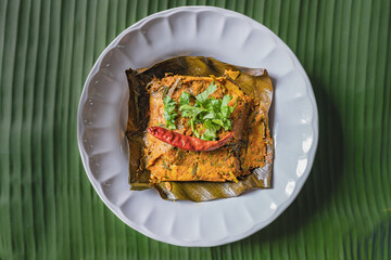 Grilled fish curry wrapped in banana leaves.