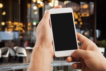 Hands hold a phone with a blank screen