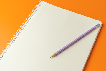 notebook to write text or message on an orange background