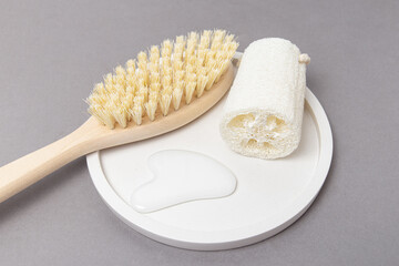 Wooden brush for anti-cellulite massage, loofah washcloth and gouache massager. Home spa