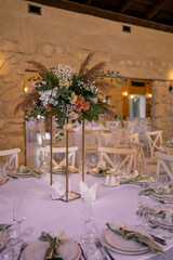 Luxury wedding table setting with flower centerpieces and candles