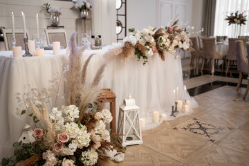 Romantic boho main table. Wedding decor with dried flowers floristry and candles, boho style.