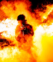 A silhouette of a soldier in fire and smoke, danger and intensity of battle. Dark outline in flames...