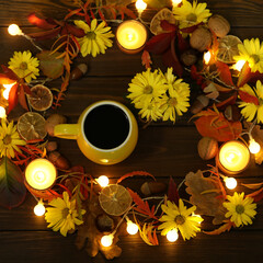 cup of coffee on the autumn background with leaves and flowers 