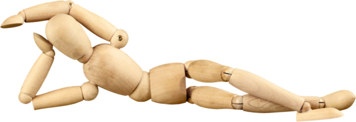 Miniature wooden mannequin in a laying down pose