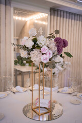 Table setting at a luxury wedding reception. Beautiful flowers on the table.