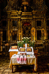 Fototapeta na wymiar Cross, golden crowns and candlesticks stand on the table in the church. Top view