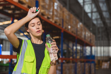 Tired stress woman staff worker sweat from hot weather in summer working in warehouse goods cargo...