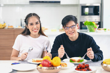 Obraz na płótnie Canvas Portrait couple Asian man and woman enjoy eating healthy food. healthcare home family people.
