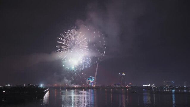 Colorful fireworks light up sky for Lunar New Year and Tet holiday over reflecting in the Han River of Danang, Vietnam.