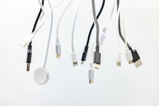 A mess of plugs and USB cables isolated in studio