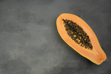 Fresh ripe papaya fruits on grey table, closeup.