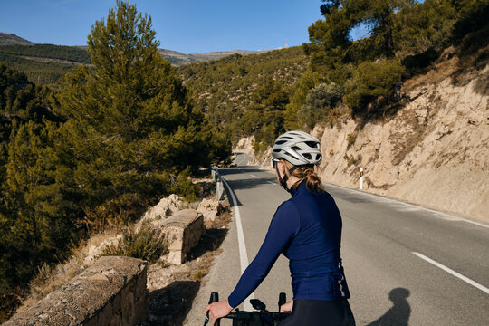 Close up back view of a female cyclist.Female cyclist wearing a long-sleeved blue cycling jersey.Motivation image.Spain