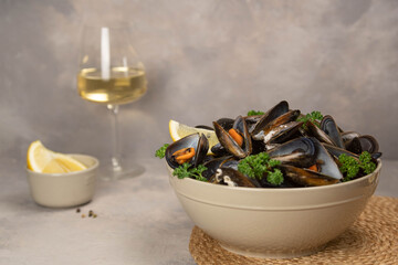 Delicious seafood mussels with with sauce and parsley. Lemon slices. Clams in the shells.
