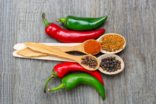 different seasonings for cooking, varieties of hot chilli pepper, ground pepper and spices, oil. for the text recipe