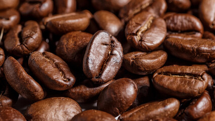 Freshly roasted coffee beans background.Dark roasted coffee beans with scoop on wooden background.