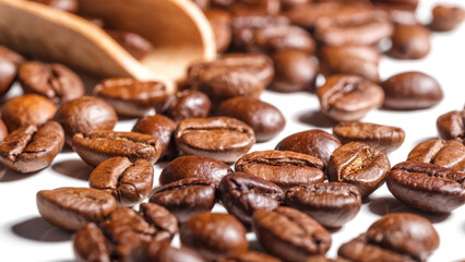 Freshly roasted coffee beans background.Dark roasted coffee beans with scoop on wooden background.