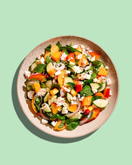 Summer peach and cheese salad on color background, top view