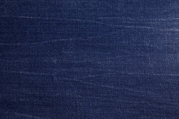 Dark blue jeans fabric background texture. Dark blue jeans fabric cloth textile material.