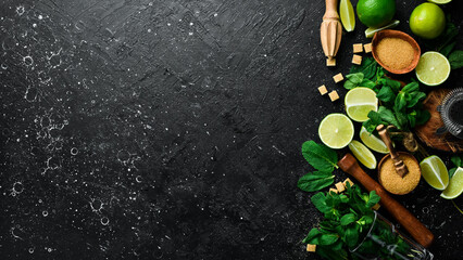 Bar banner with the preparation of a cooling mint cocktail. Mojito: lime, mint and brown sugar. On a black background. Top view.